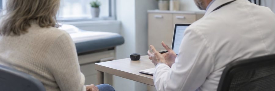 AI generated illustration of a doctor and patient talking with a small recording device on the desk