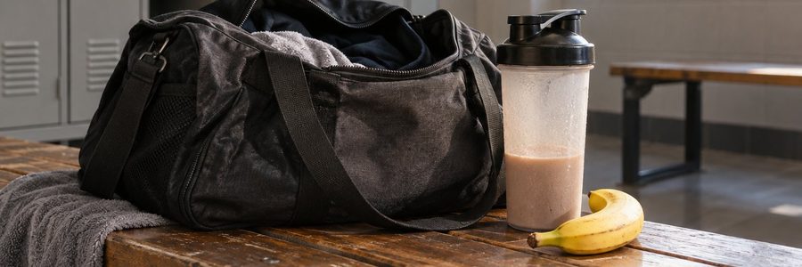 AI generated illustration of a gym bag, shaker bottle, and banana on a locker room bench
