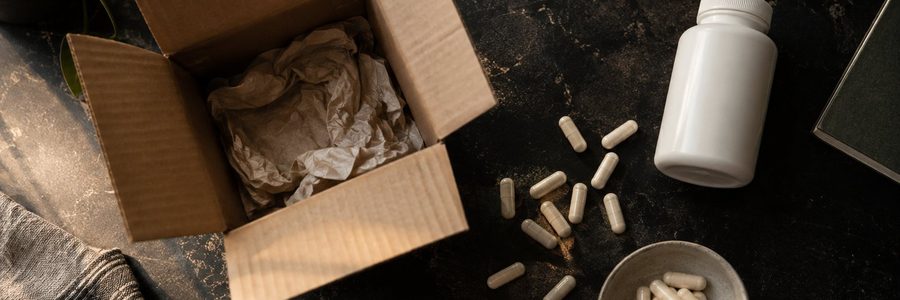AI generated illustration of unlabeled capsules beside an open shipping box